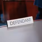 a desk with a sign on it that says defend