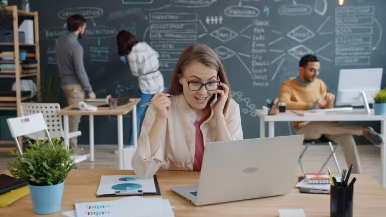 Woman celebrating success while on a business call