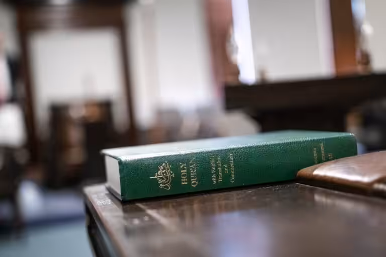 a green book sitting on top of a wooden table