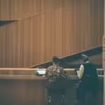 a couple of people that are standing at a counter